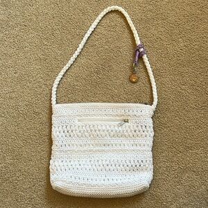 Lina white crocheted purse with purple accent.